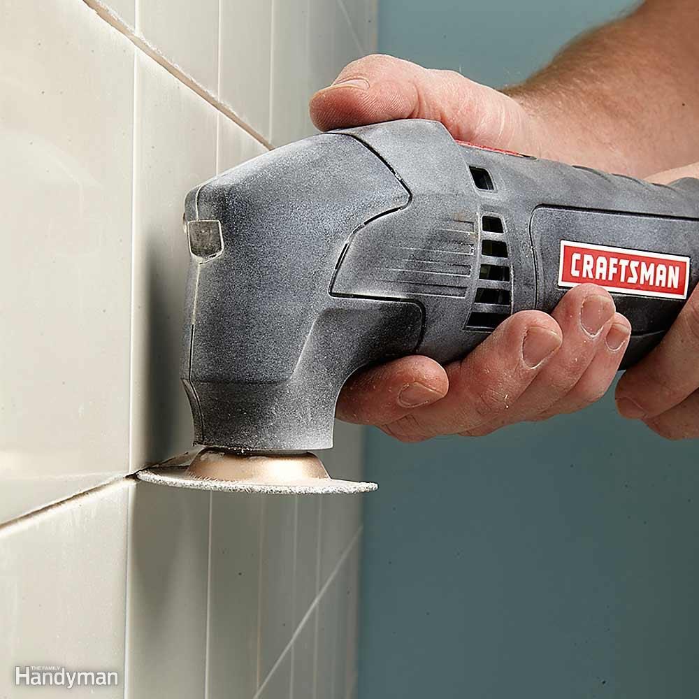 Removing tile grout with an oscillating tool