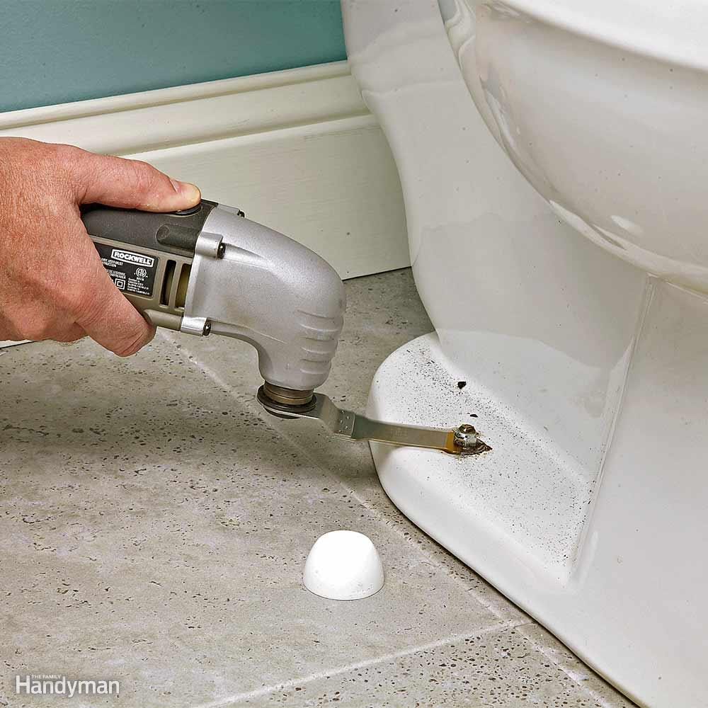 Cutting off corroded bolts from a toilet with an oscillating tool