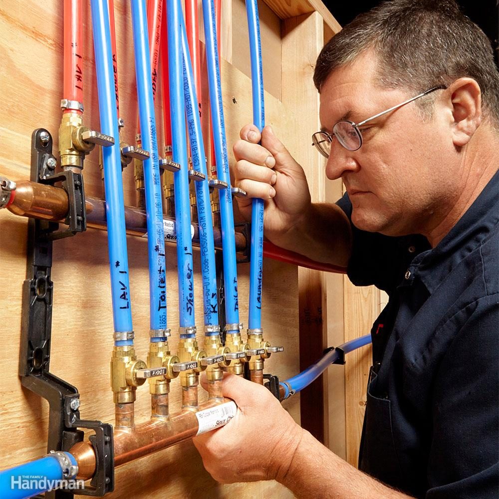 Man inspects PEX pipe lines