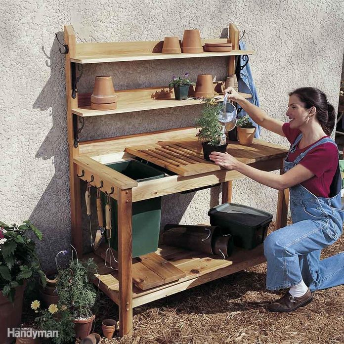 cedar potting bench DIY Backyard Idea - Woman Watering Plants on New IDY Potting Bench