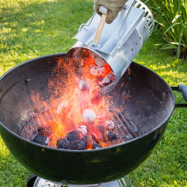 charcoal chimney pouring hot coals in grill