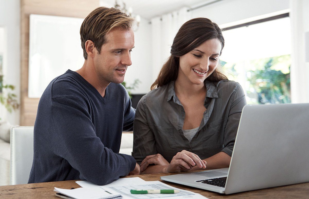 Two people looking at a computer screen | Construction Pro Tips