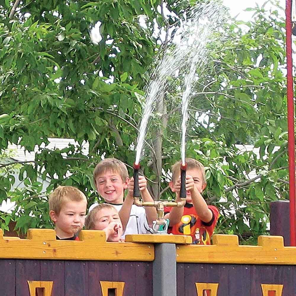 Children play with a water cannon on top of a treehouse