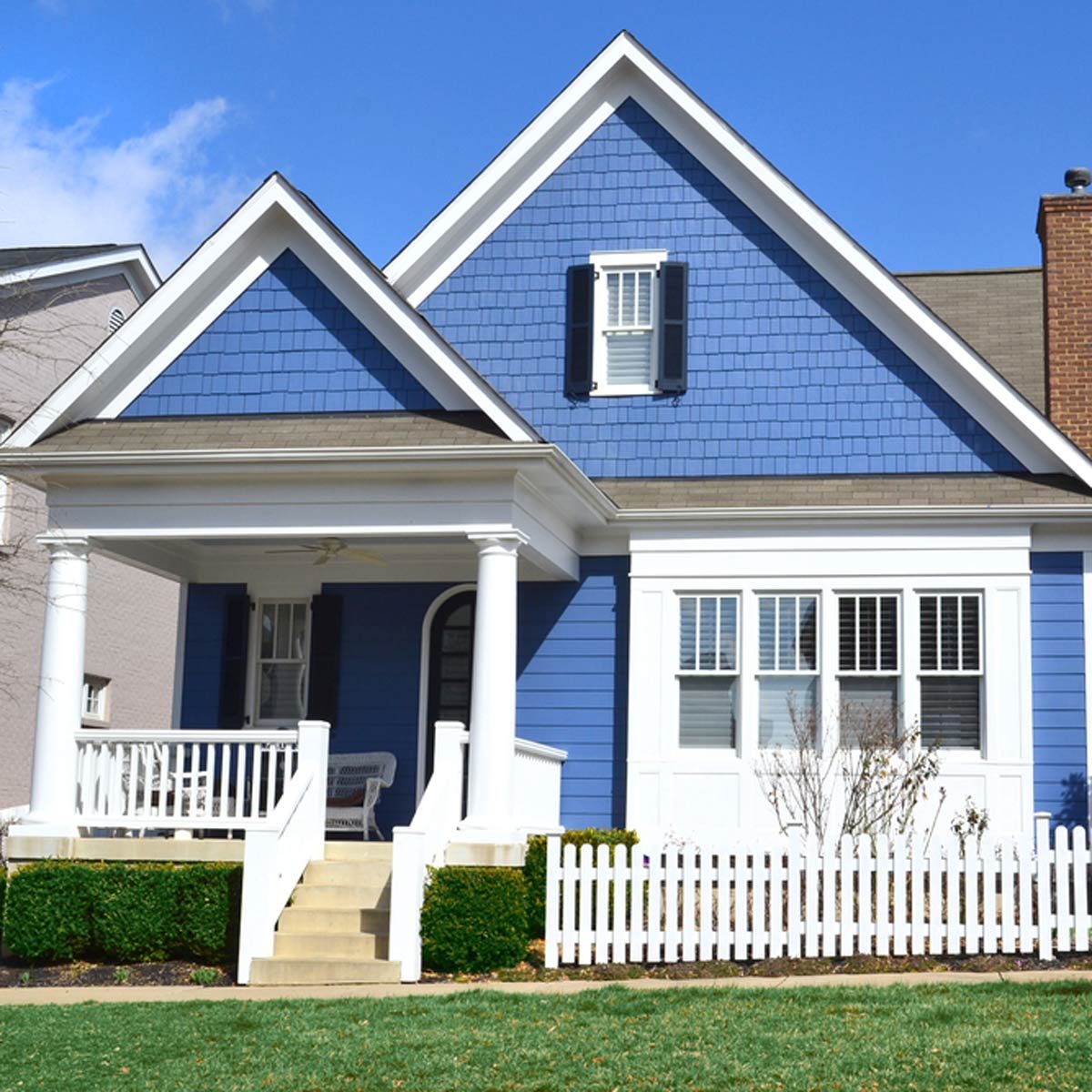 shutterstock_121617061 buying first home blue house with white trim front porch