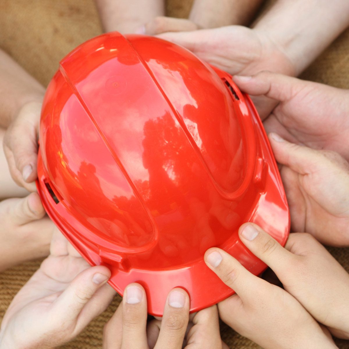 shutterstock_275728781-1200x1200 hands on a hard hat