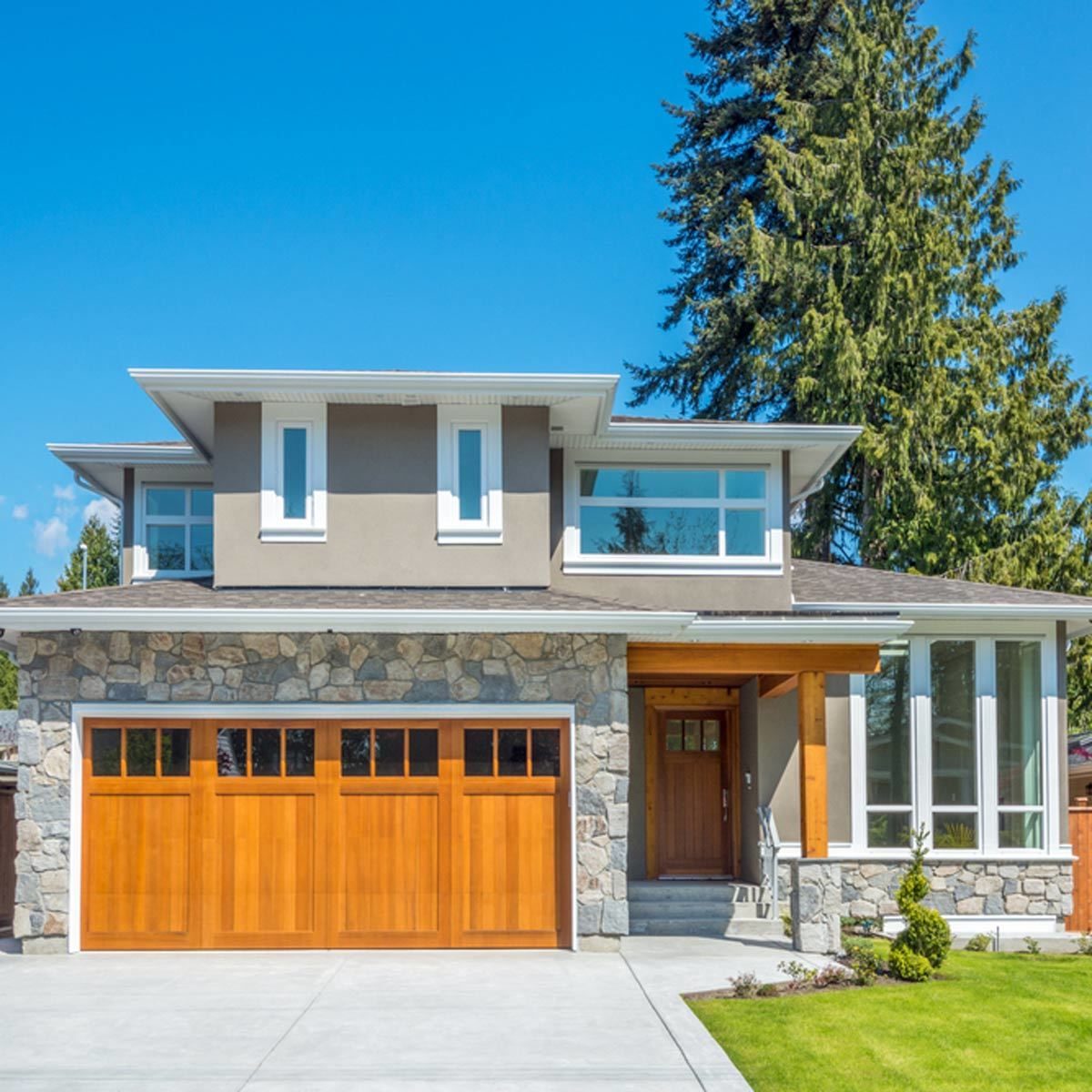 home exterior with wooden garage doors