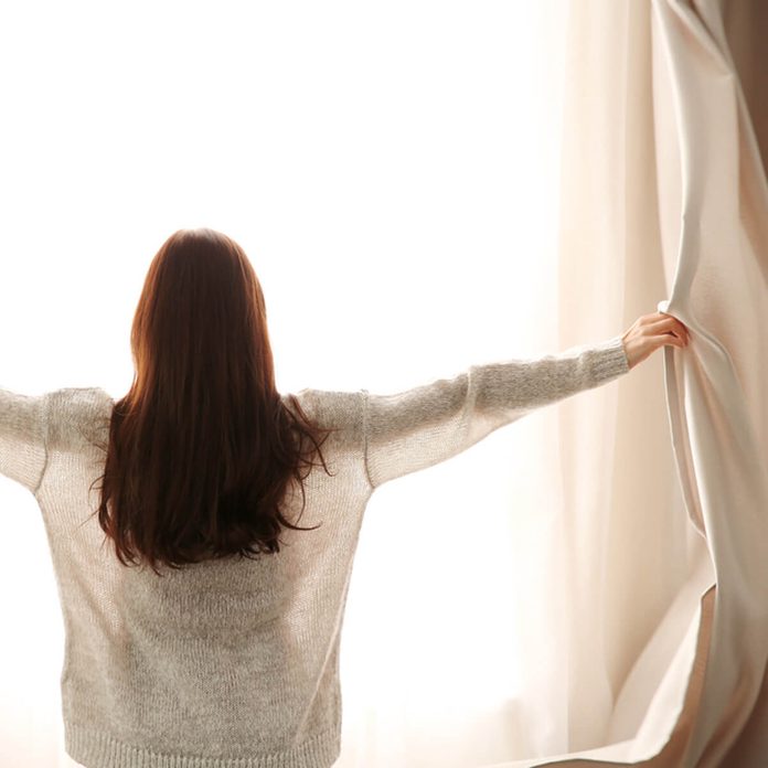 dfh4_shutterstock_544153177 open up blinds curtains to let sun in