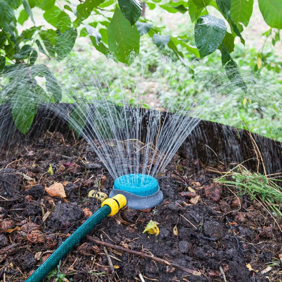 fh10_469599989 sprinkler watering plants grass compost