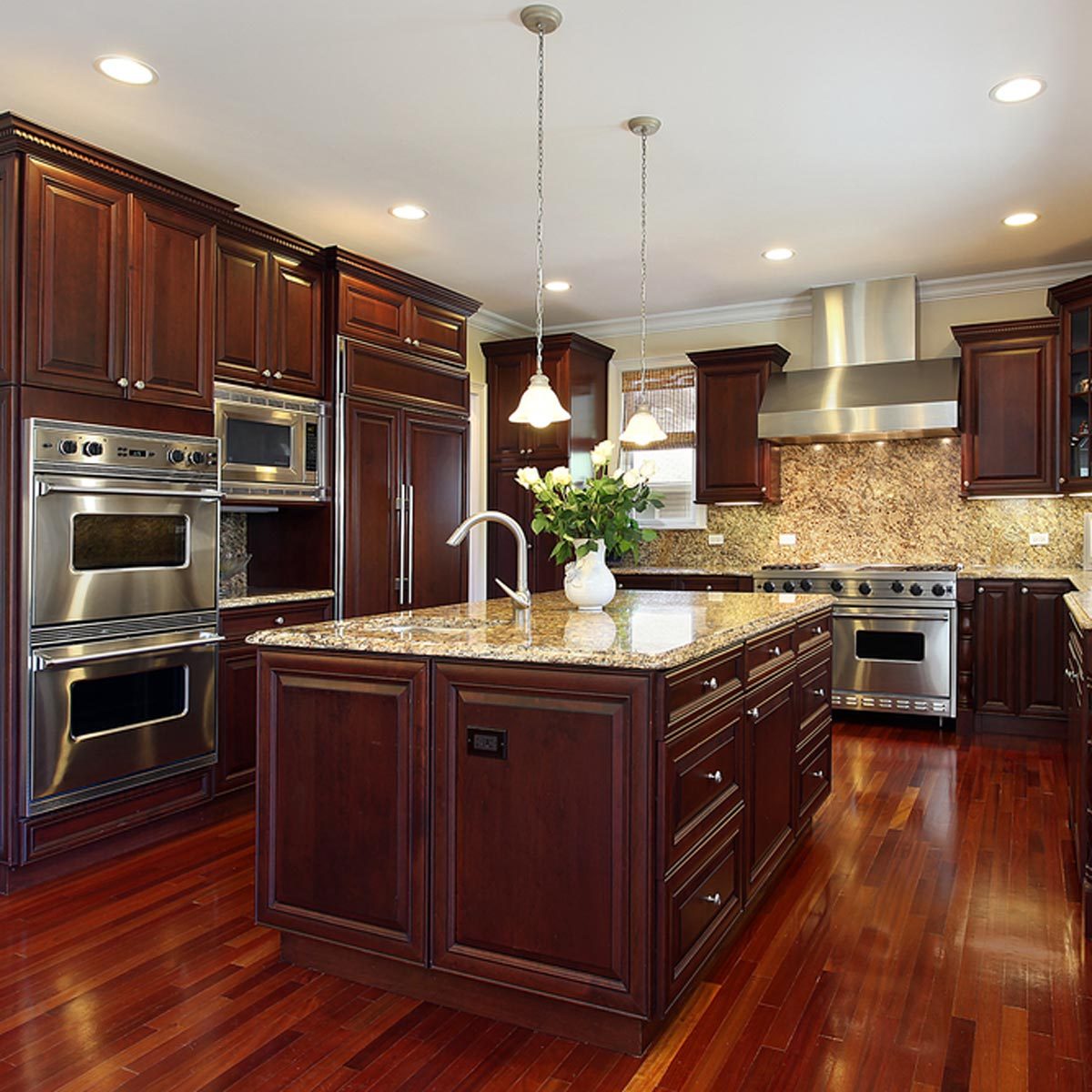 shutterstock_48791098 kitchen island dark wood cabinets granite counter tops kitchen island electrical outlet