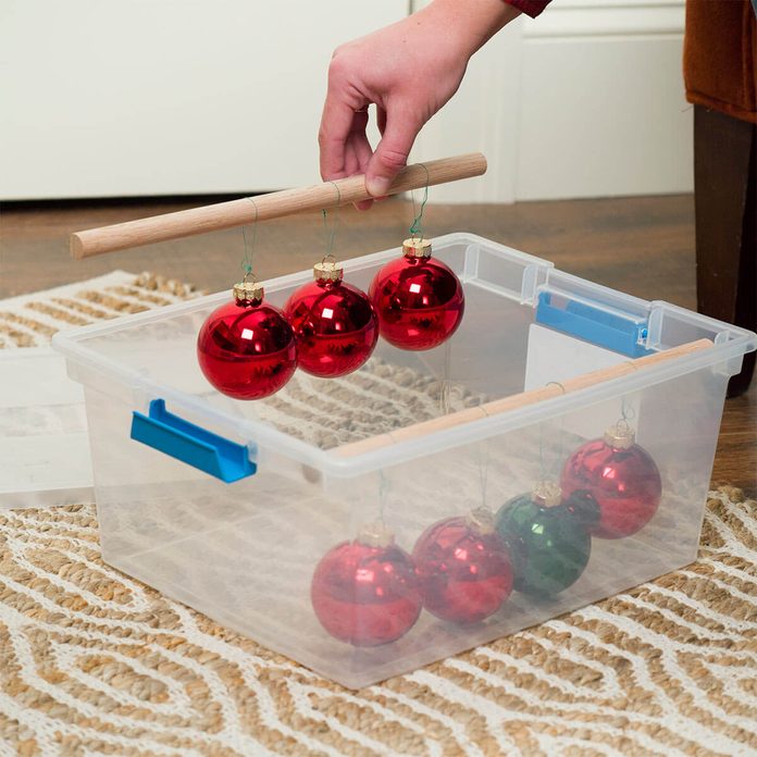 hang ornaments on dowels inside bin