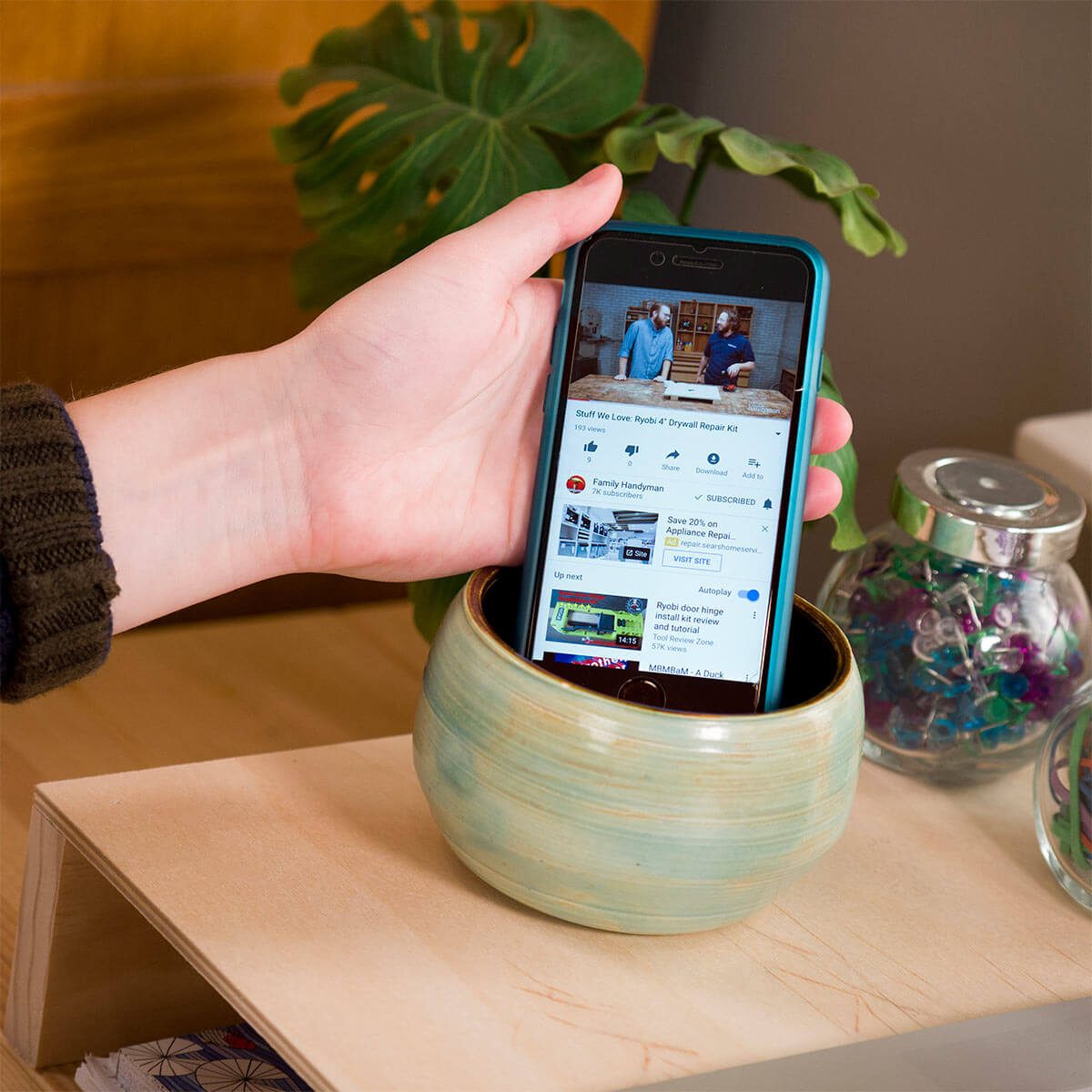 placing smartphone in pottery