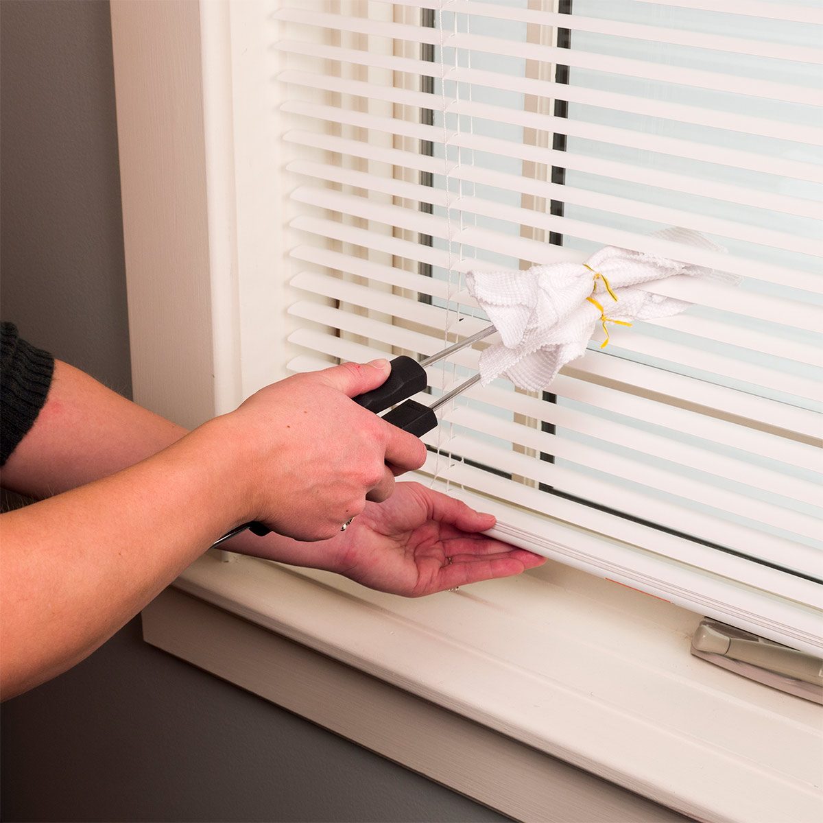 cleaning blinds with kitchen tongs