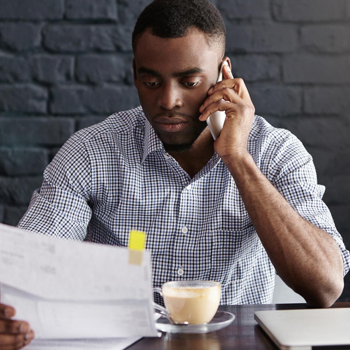 man researching business contact references on the phone