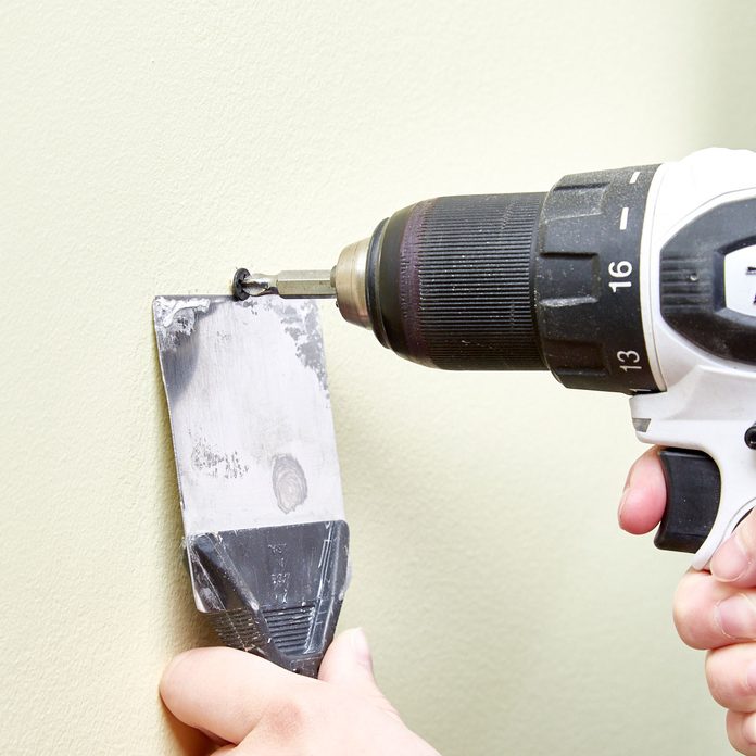 HH removing drywall screw with a putty knife