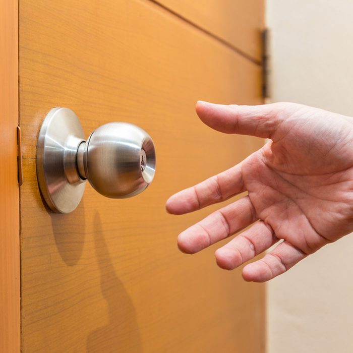 reaching for door handle to open door