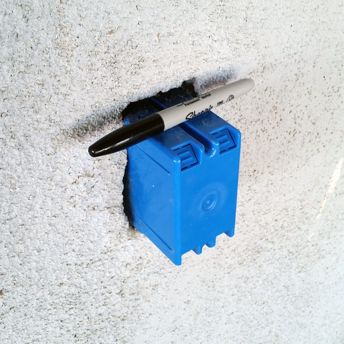 Sharpie resting on temporary outlet box | Construction Pro Tip