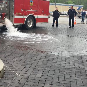 Firetruck dumping water on pavers