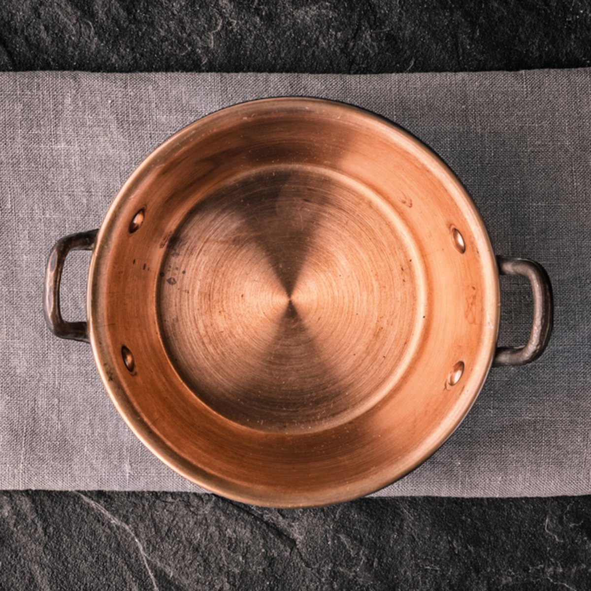 Copper pot on the dark stone table top view; Shutterstock ID 395567689; Job (TFH, TOH, RD, BNB, CWM, CM): TOH