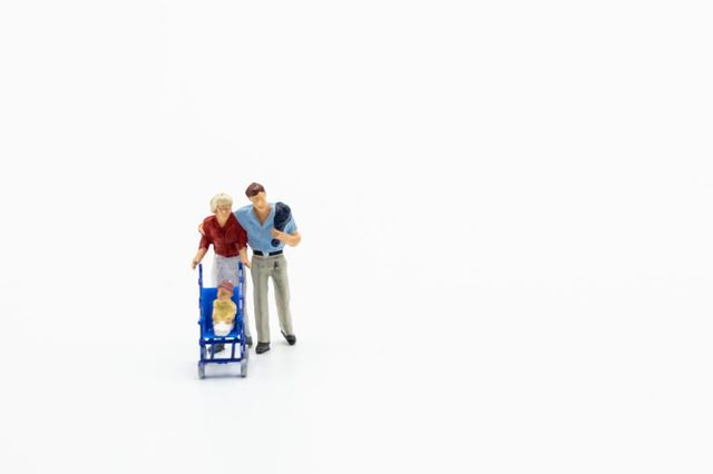 Miniature people, family and children isolated on white background. International Day of Families