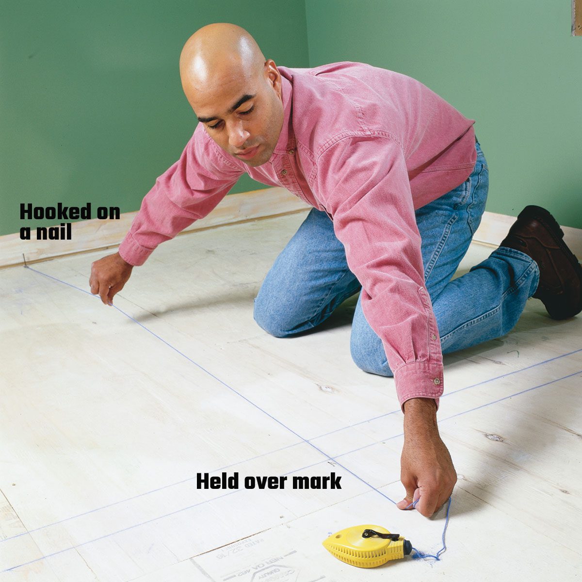 Hooking a chalk line on a nail to make a line | Construction Pro Tips