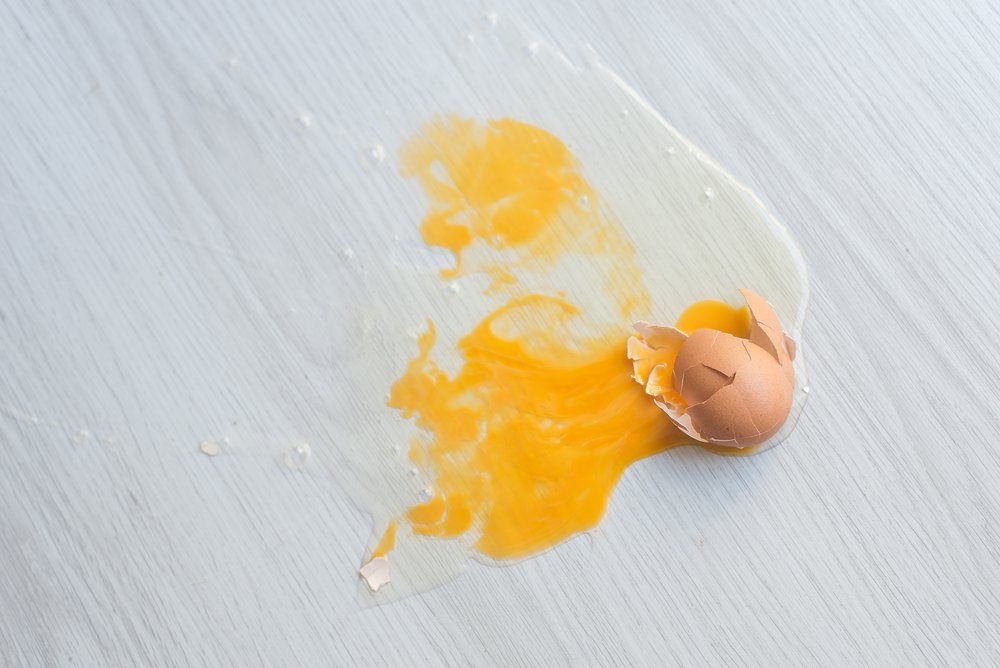 Broken egg on floor.