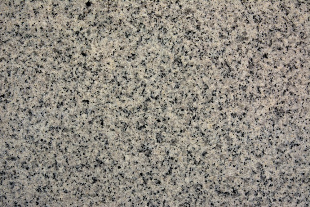 Polished granite texture with pink hues and black