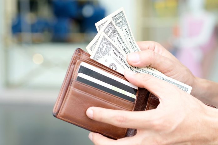 Hand of men use money from wallets. Pay the dollar Financial concepts and expenditures,