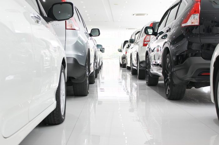 A row of new cars parked at a car dealership stock, New Japanese cars in showroom for show customers.