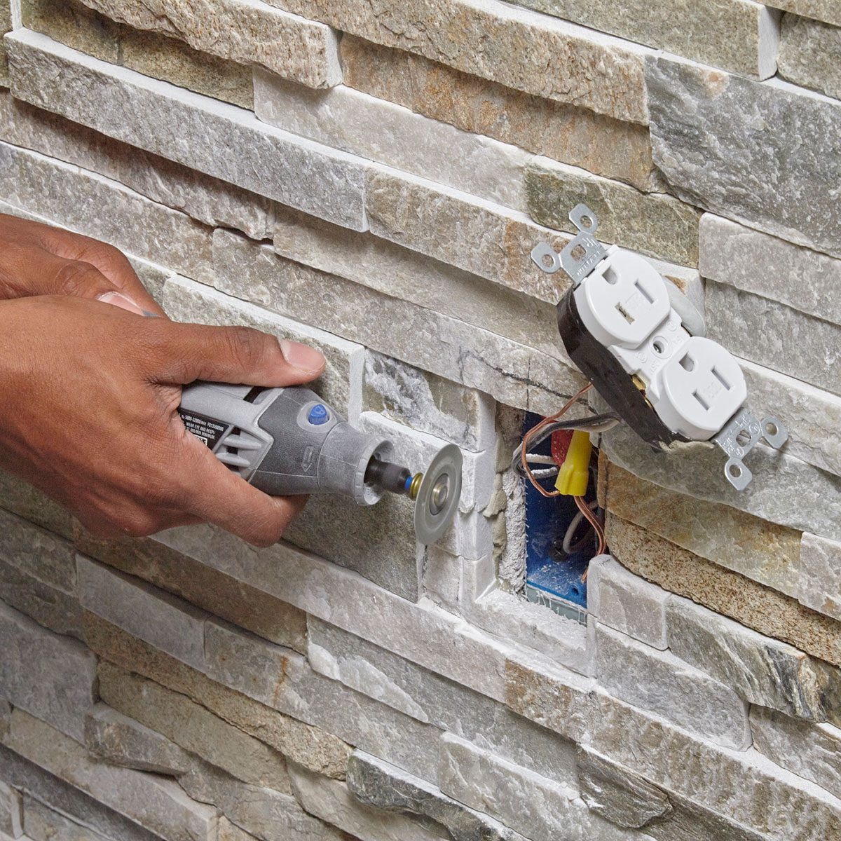 Grinding out the stones around the outlet space 