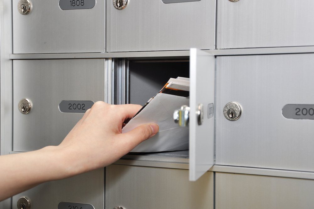 Woman taking some letters from mailbox