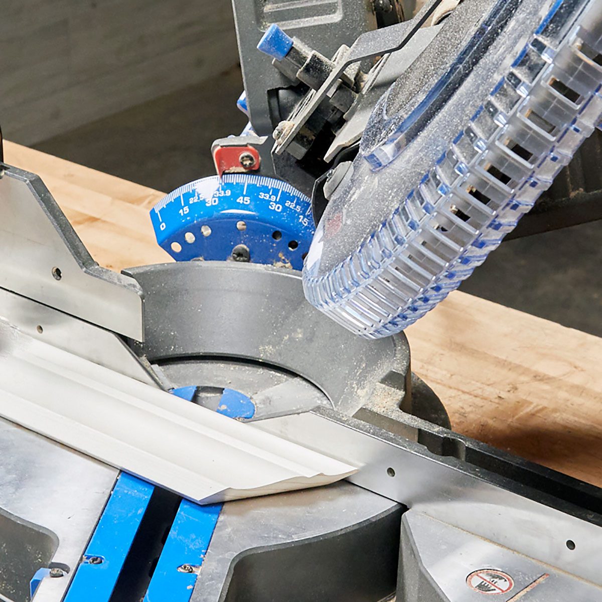 Cutting crown flat on a saw A piece of crown molding laid flat on a miter saw | Construction Pro Tips