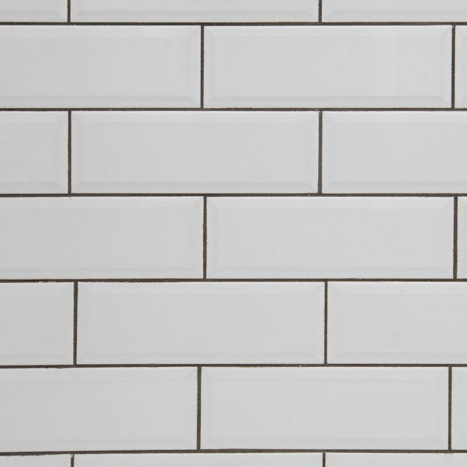 White subway tile wall and dark grout for a kitchen or bathroom backsplash