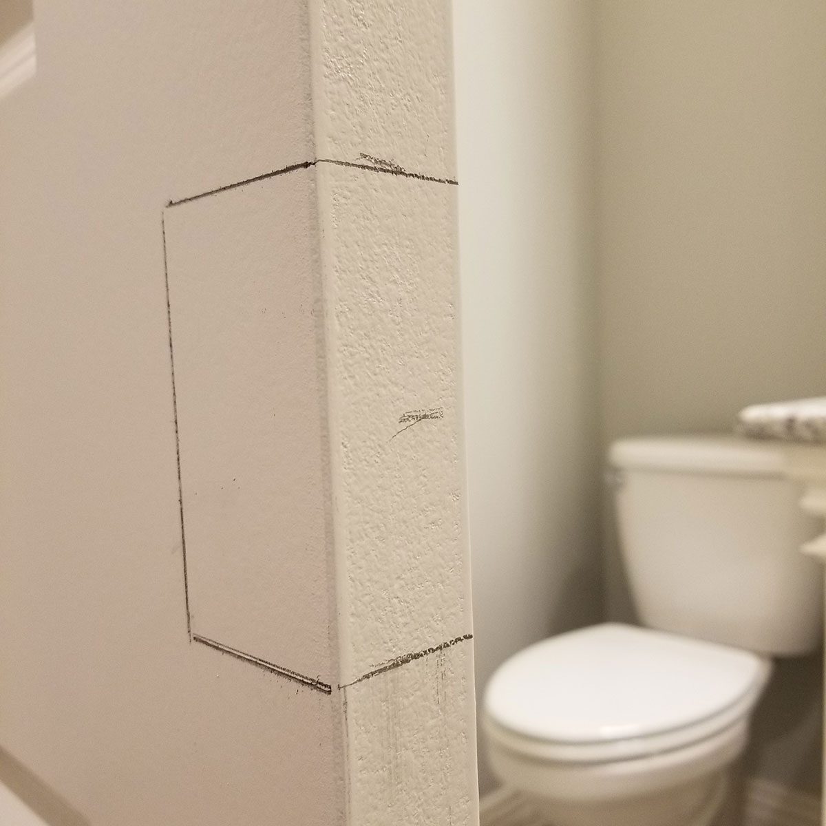 Careful Cuts Where the Pocket Door Hardware Will Go | Construction Pro Tips