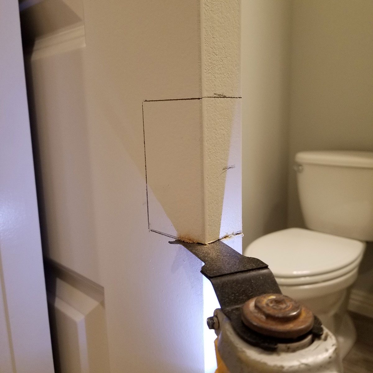 Cutting into a door with a multitool | Construction Pro Tips