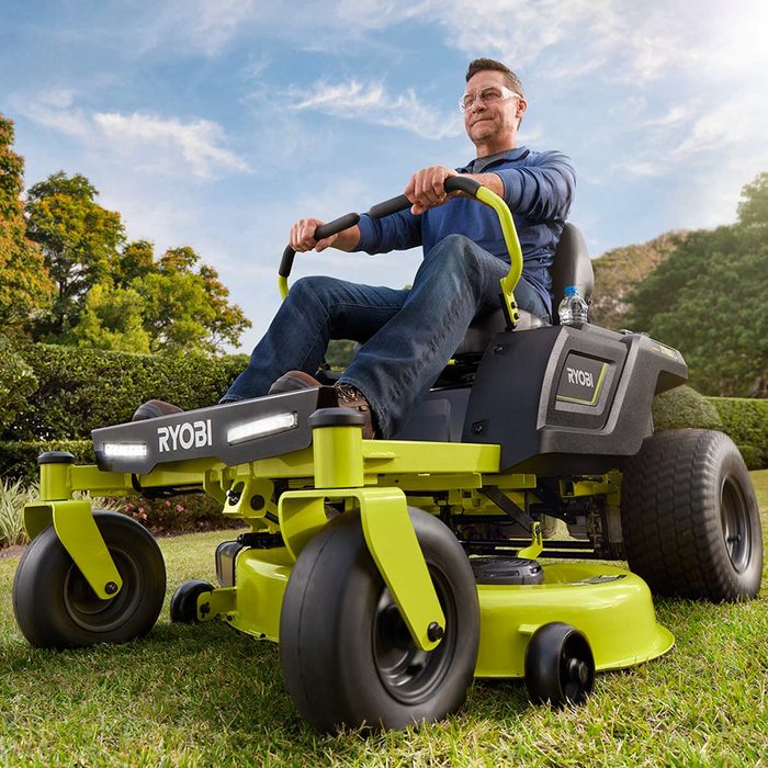 Man on a Ryobi Battery Powered Zero Turn Riding Lawn Mower