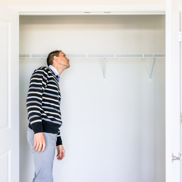 man looking in closet