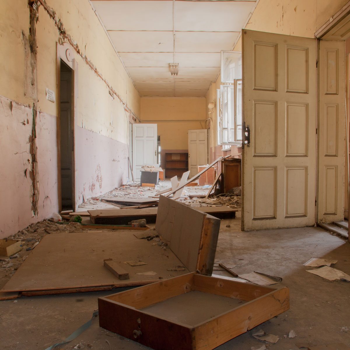 Abandoned-corridor-and-destroyed-desks-and-lockers-in-an-old-school-building-Sofia-Bulgaria