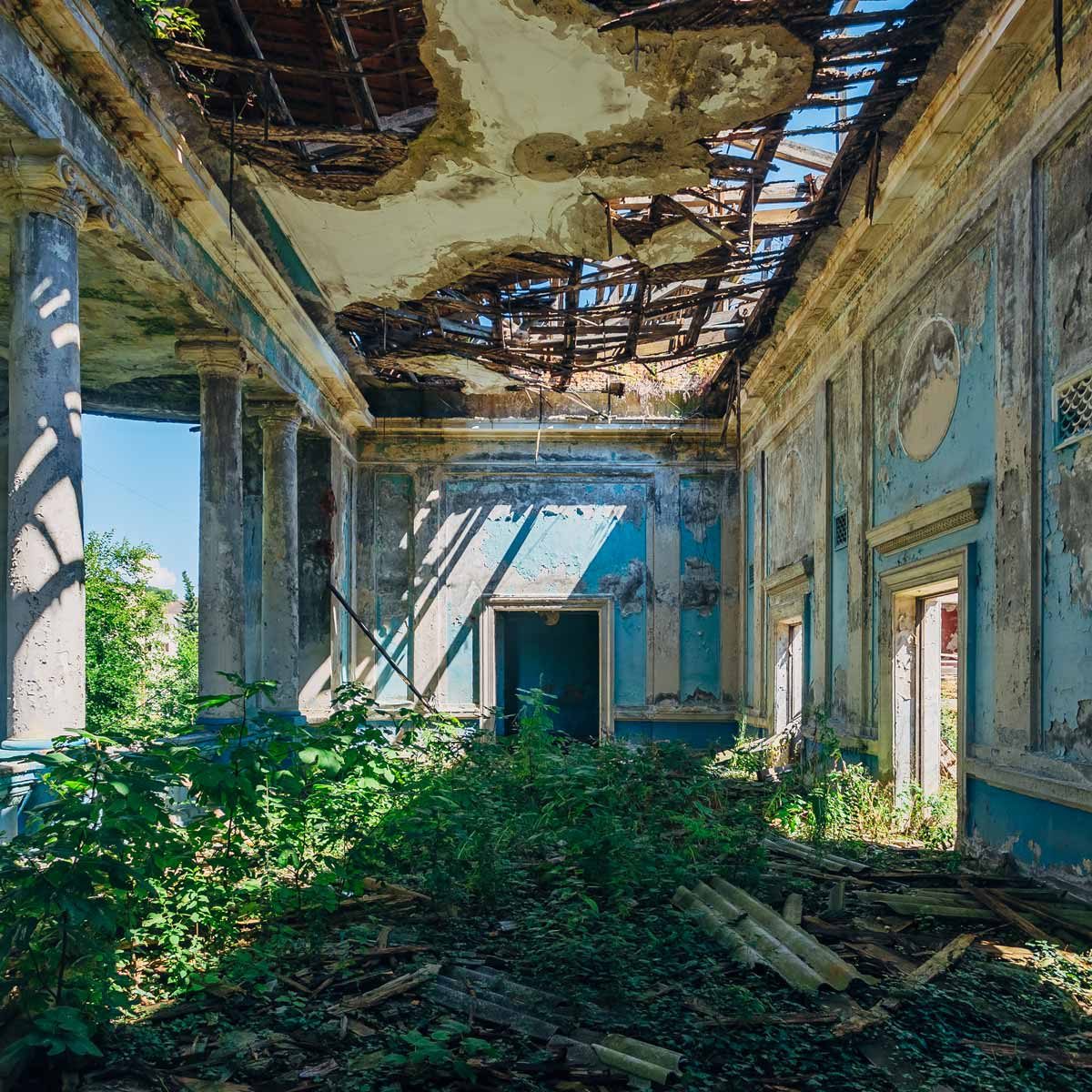 Ruined-abandoned-mansion-overgrown-with-weeds