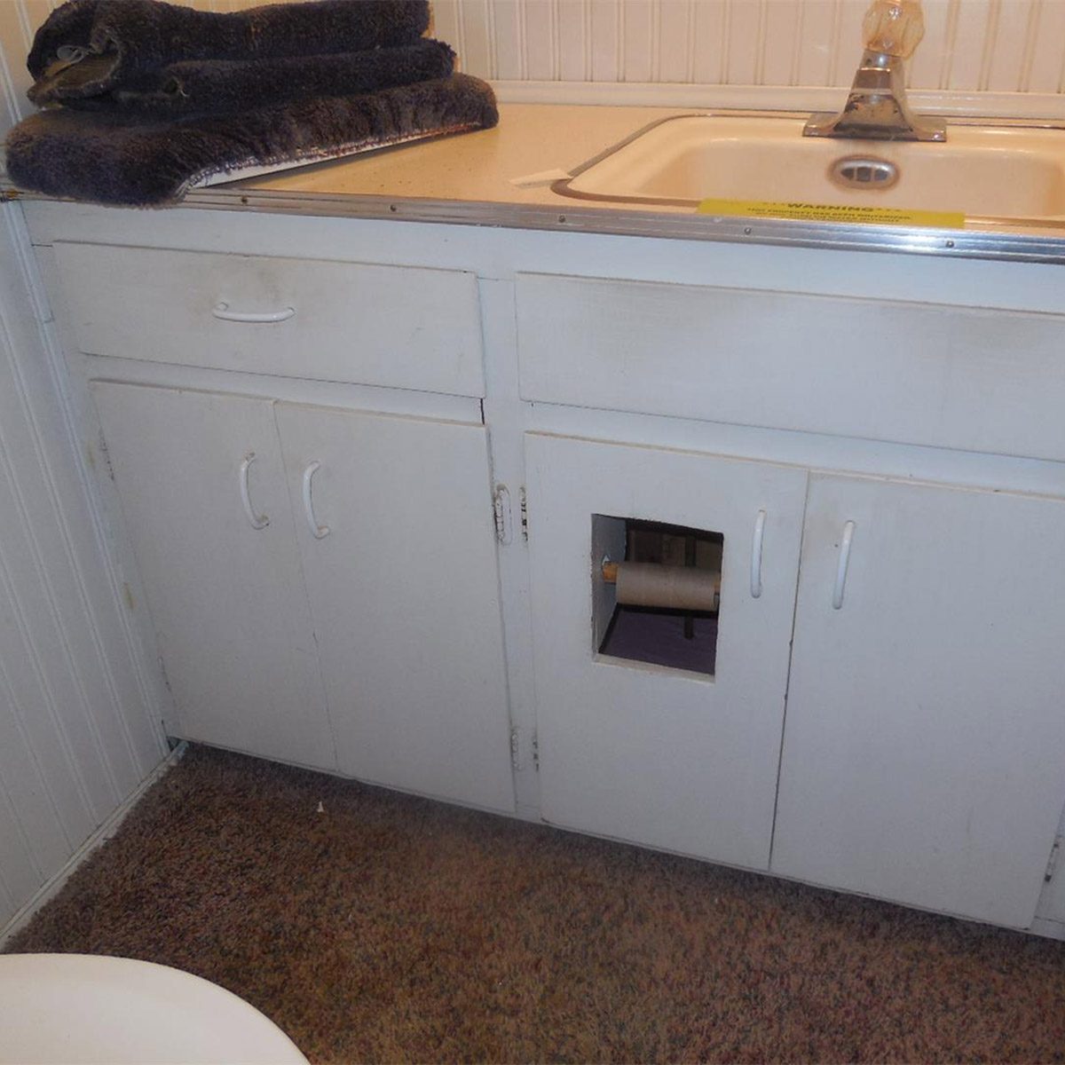 toilet paper holder in cabinet