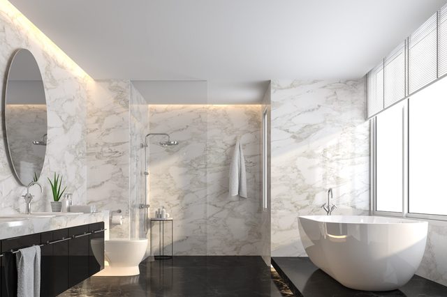 Luxury bathroom with black marble floor and white marble wall 3d render,The room has a clear glass shower partition,There are large windows natural light shining into the room.