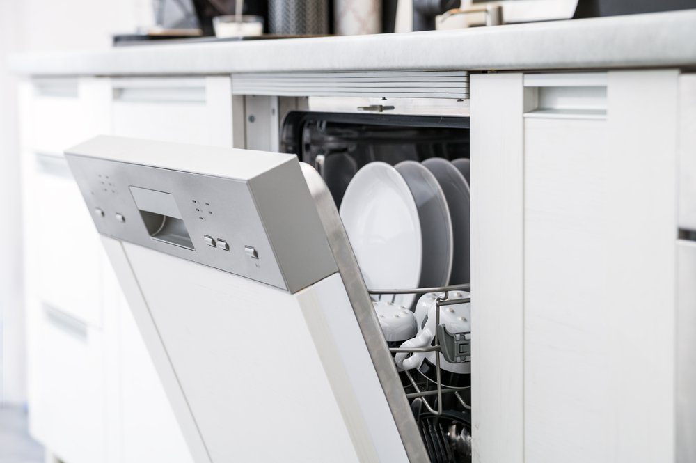 Open dishwasher with clean dishes after washing