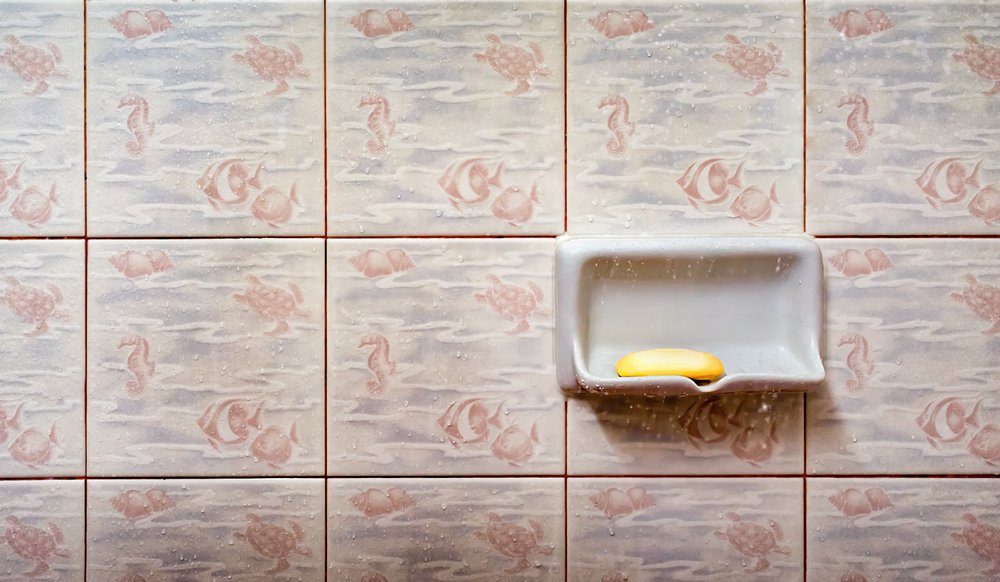 A Used Bar Soap on a Soap Tray in the Shower