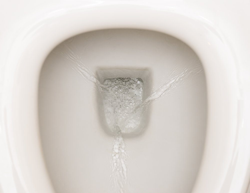 Open White a toilet bowl Flowing water Close-up