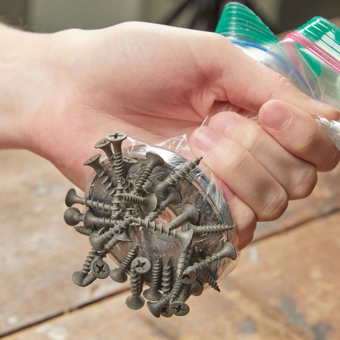 HH pick up a spill of screws with magnet or plastic bag