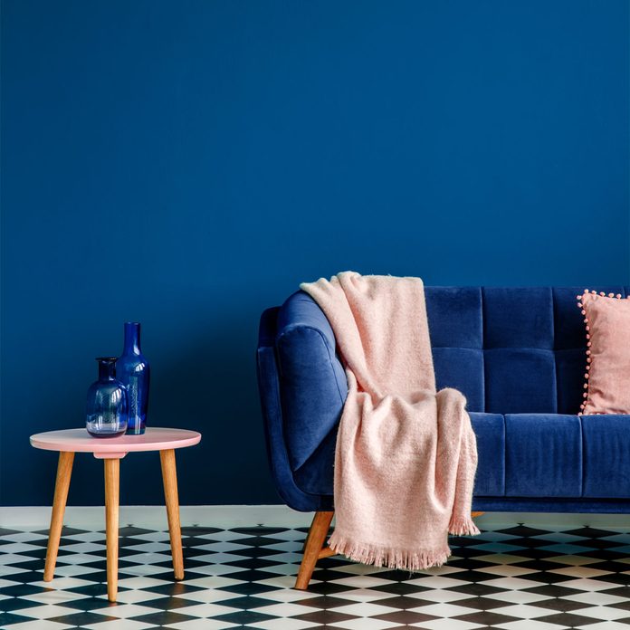 living room with blue wall and blue couch