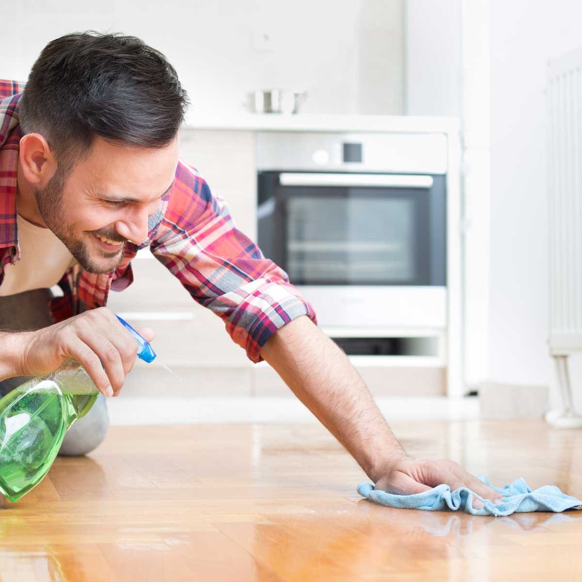 man cleaning hardwood floor