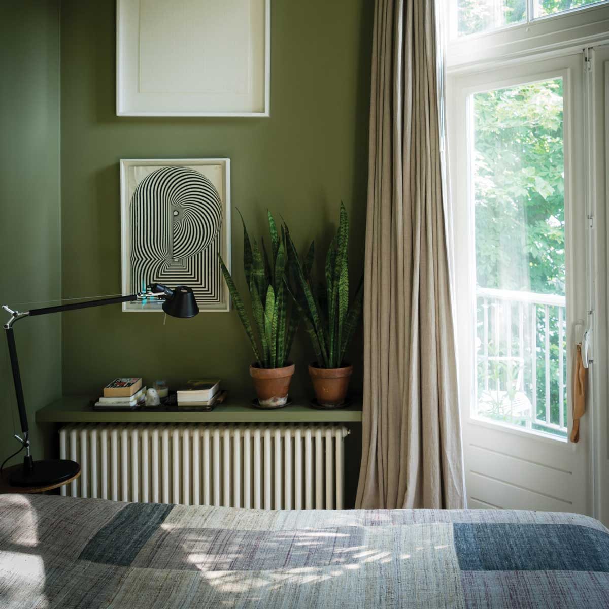 Bedroom with green walls and natural materials