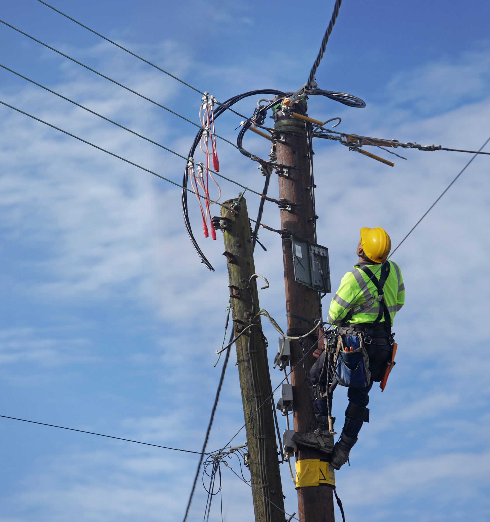 Man up pole working on power lines