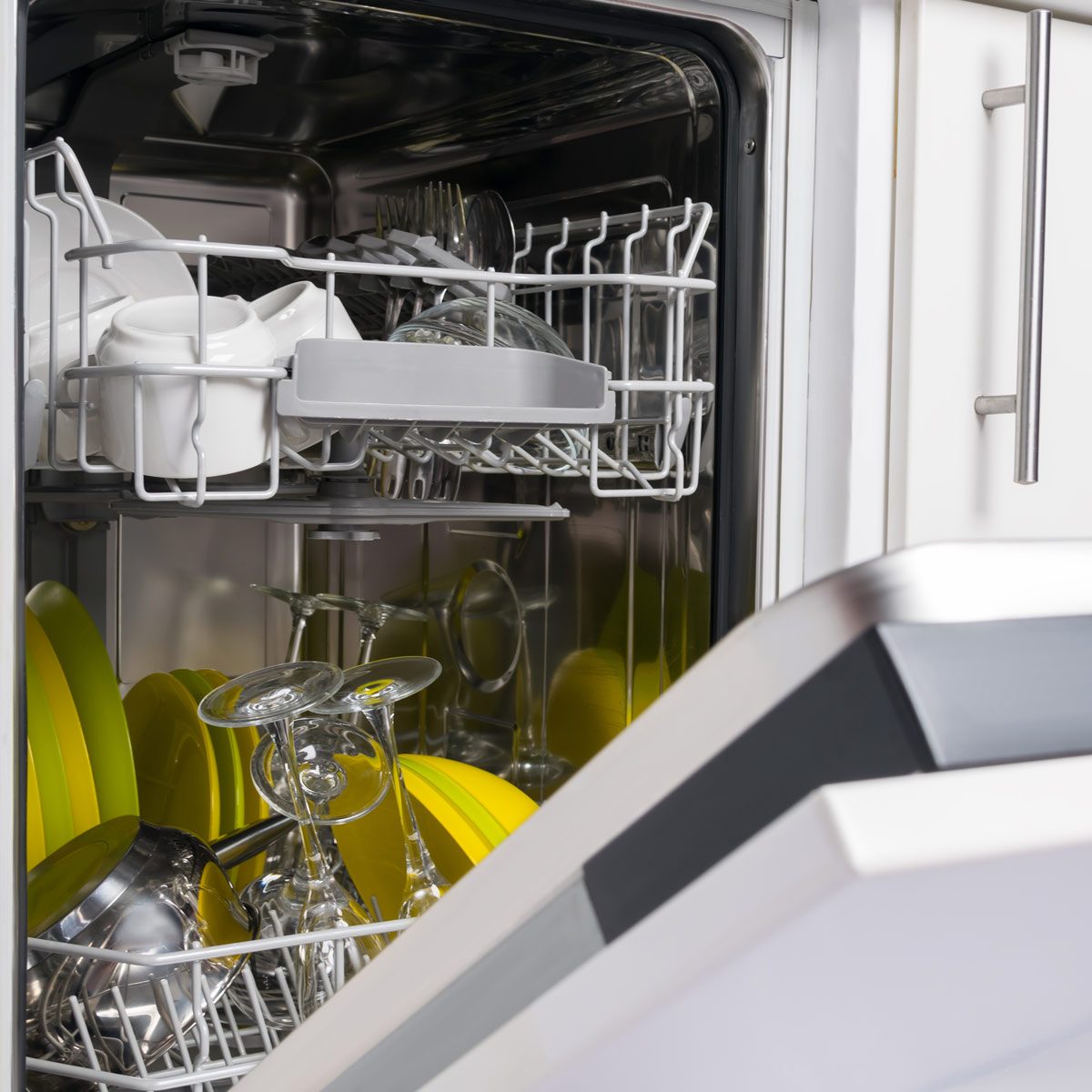 open dishwasher door with clean dishes inside