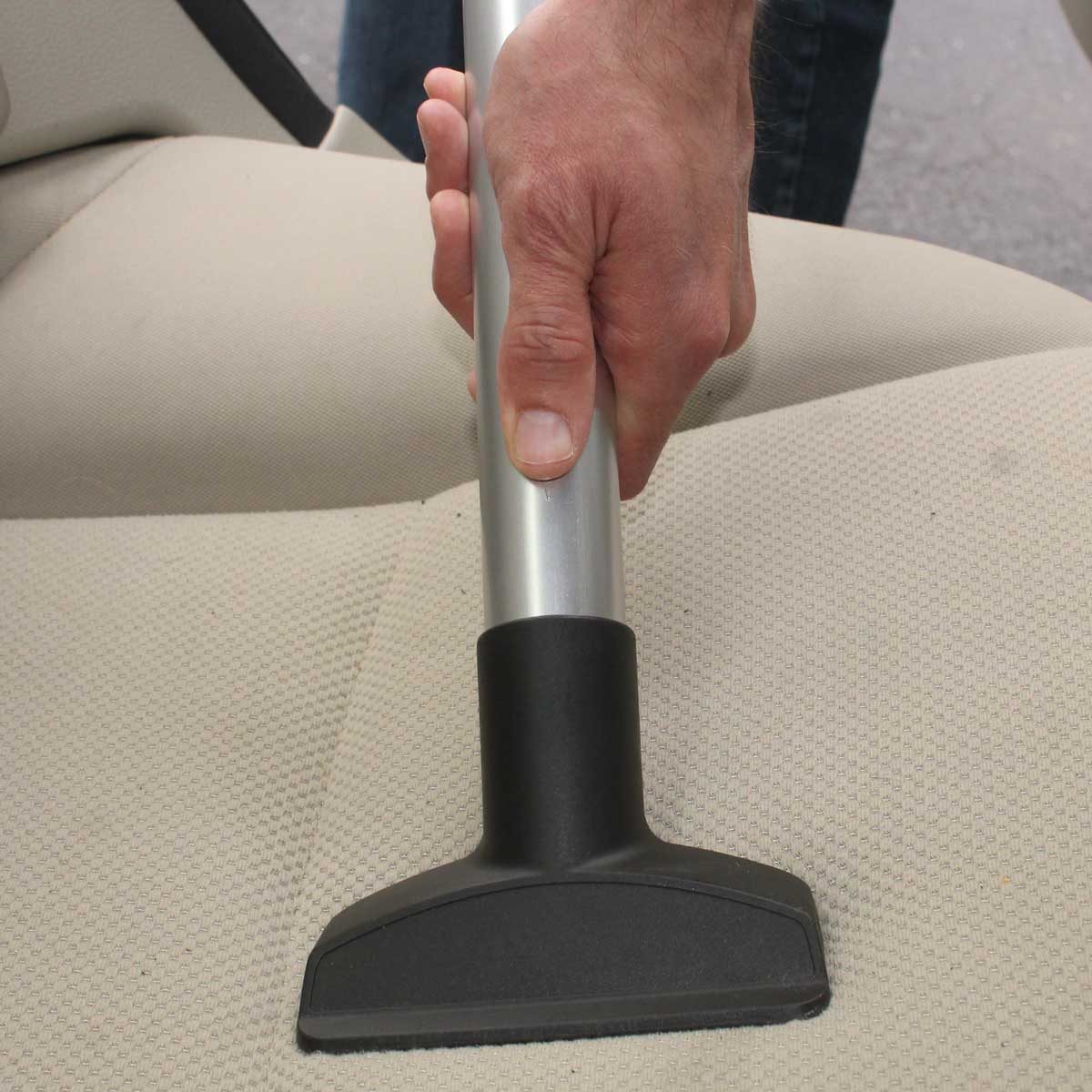 Vacuuming a cloth car seat